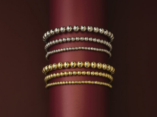 dramatic dark red background showing bright beaded bracelets