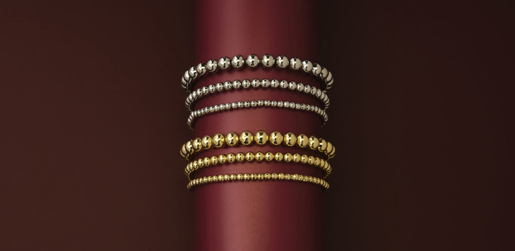 dramatic dark red background showing bright beaded bracelets