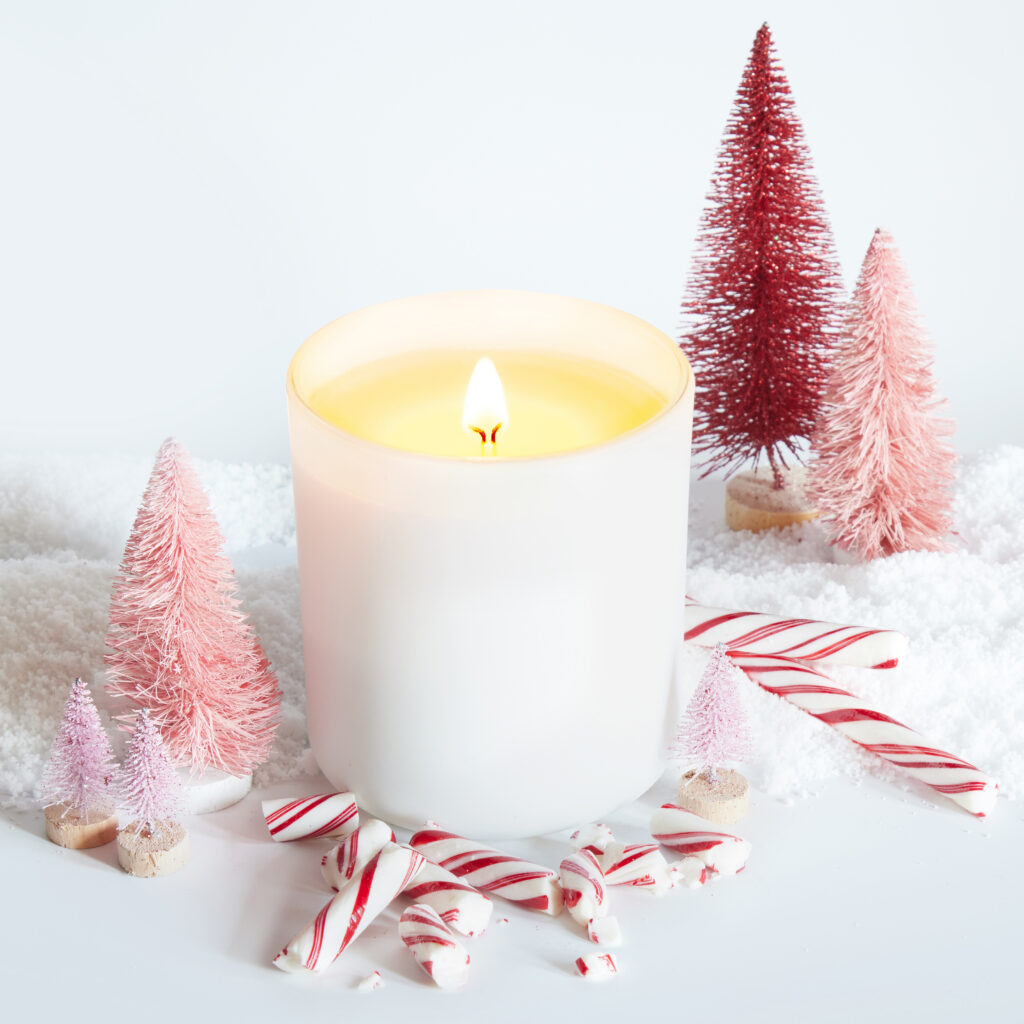 Cue Candle Company white candle with candy canes and pink trees in snowy white scene