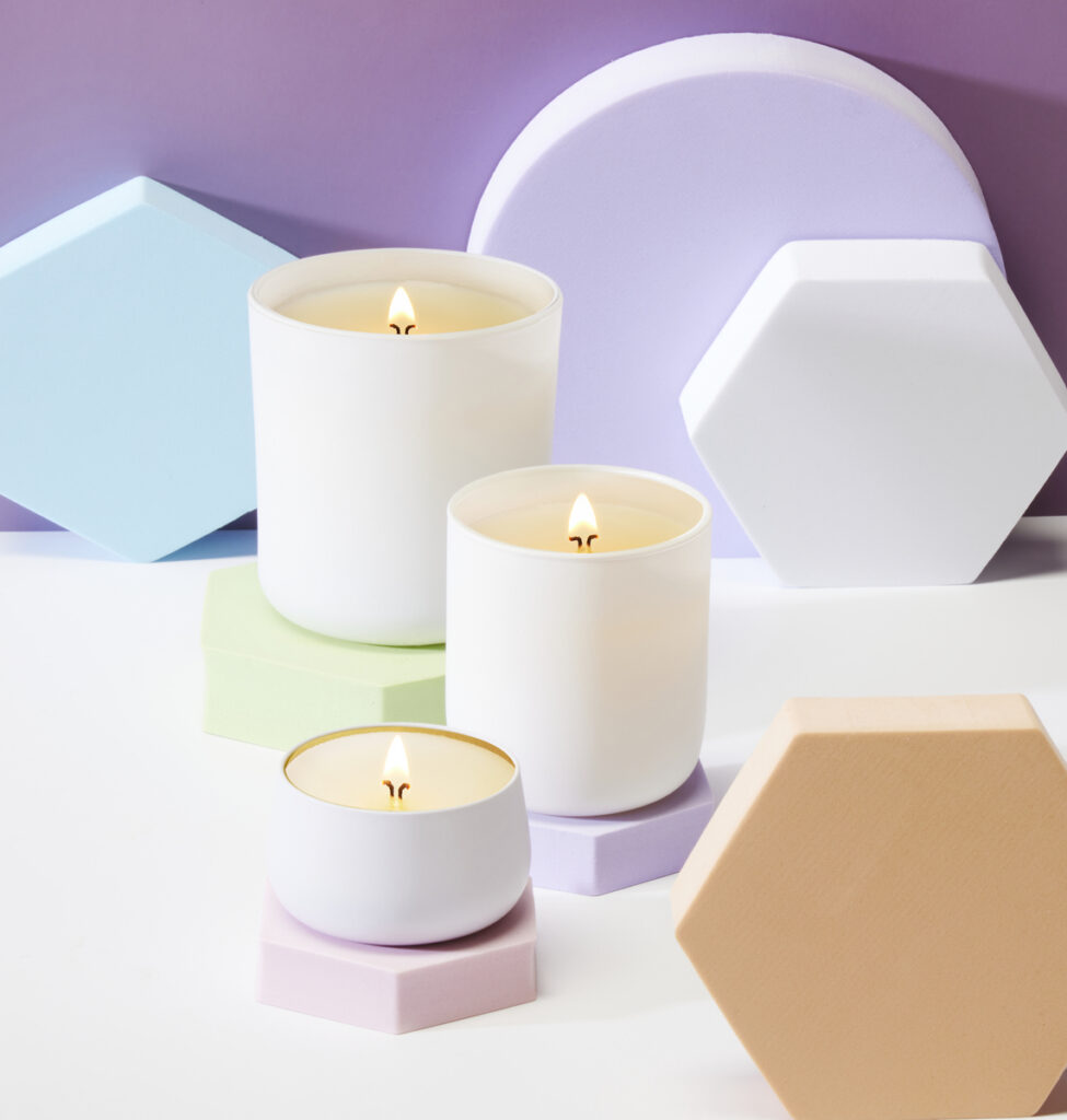 Cue Candle Company white candles with pastel geometric risers and purple background
