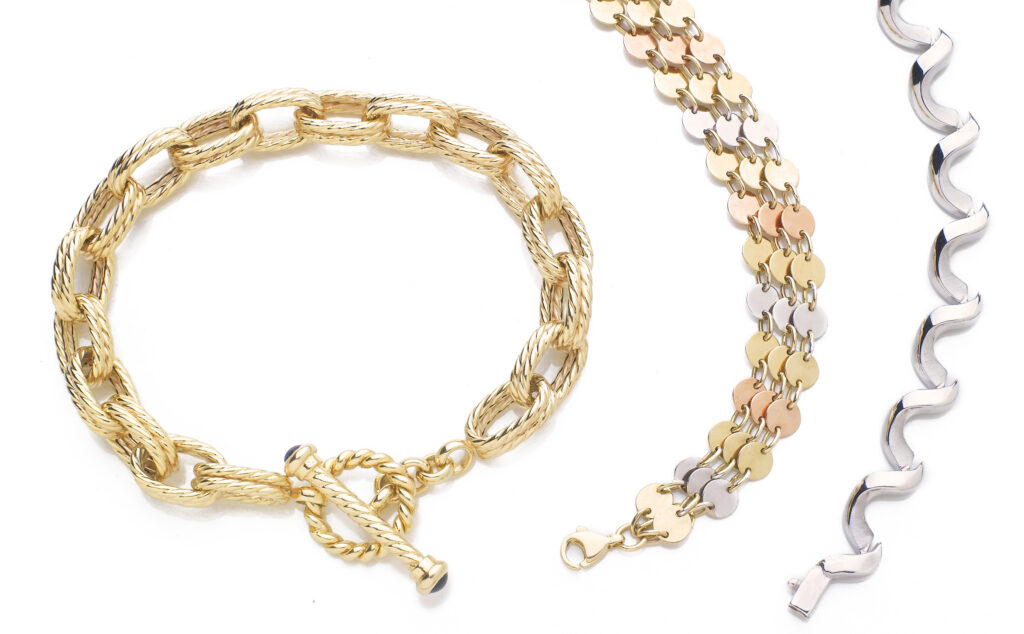 Gold and silver bracelets on a white background