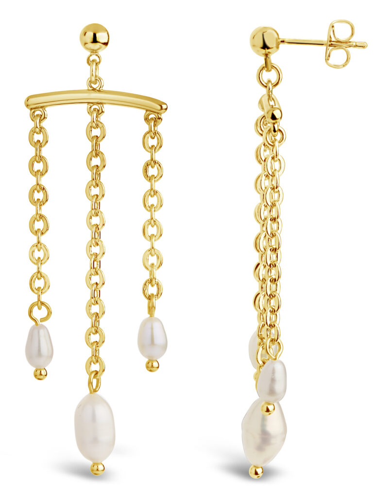 Gold chain and pearl dangle earrings on white background