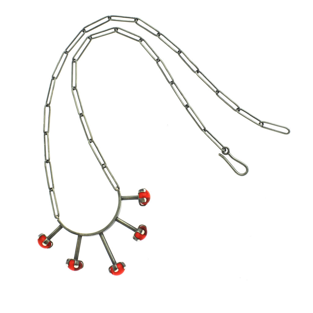 handcrafted necklace with red gems on a white background