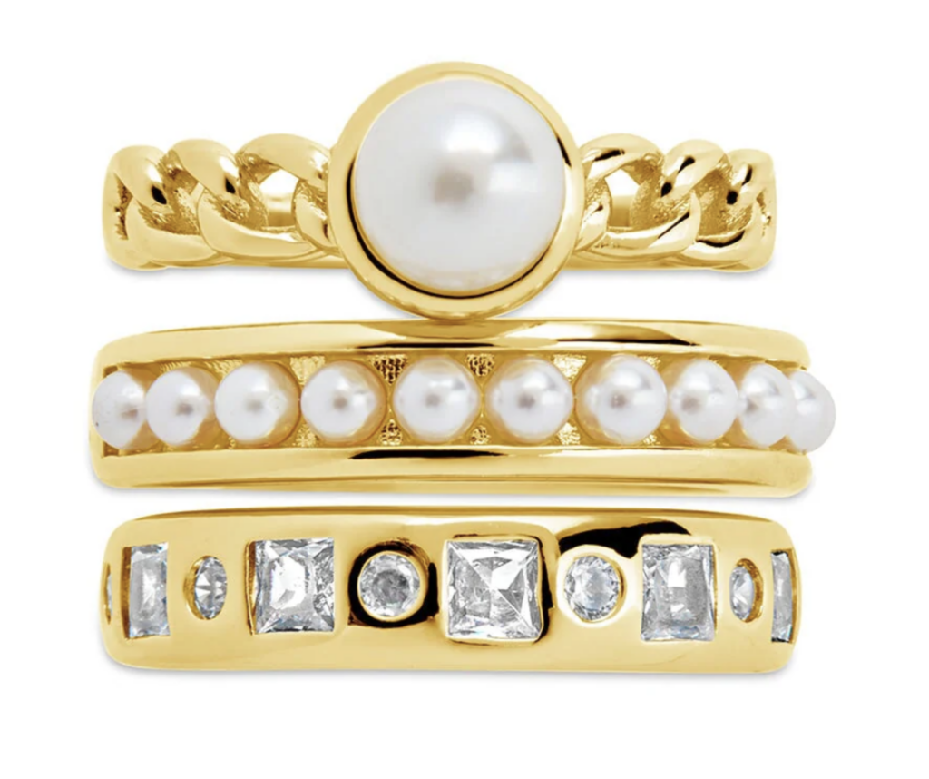 gold pearl and diamond ring set on a white background