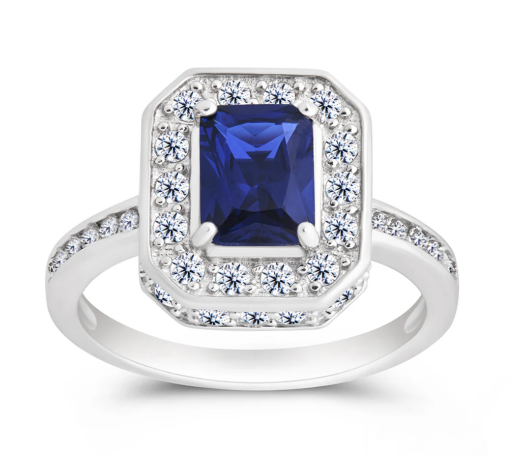 silver and sapphire cocktail ring on a white background