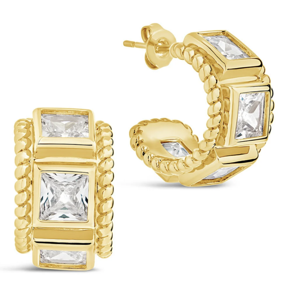 gold and diamond earrings on a white background