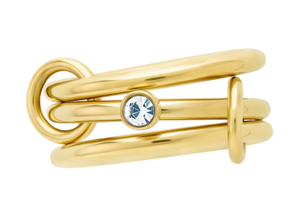 gold and diamond stacker ring on a white background